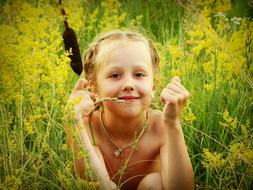 happy caucasian child Girl in tall Grass