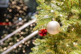 decorative balls on artificial spruce close-up on blurred background