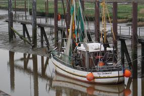 fishing boat near the wooden bridge