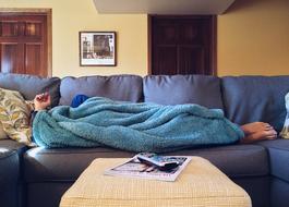 male person sleeps on sofa at home