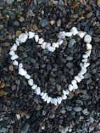 a heart of white rocks on the beach