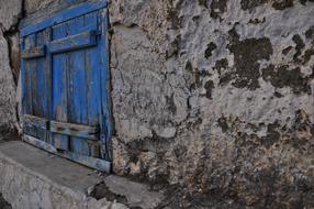 old blue shutters on a stone building in Cyprus