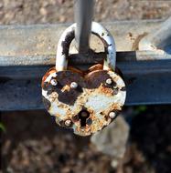 The rusty heart lock on the bridge