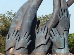 bronze sculpture outdoor, palms and stretched hands