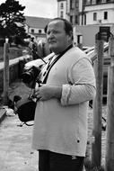 male photographer on a city street in black and white background