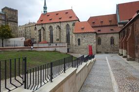 fenced walk path along wall of Gothic Monastery in Europe