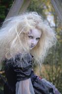 blonde with tousled hair in a witch costume