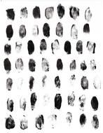 Different black fingerprints on a white sheet