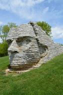 stone sphinx by the grass