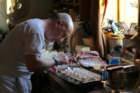 cook prepares meals in the kitchen