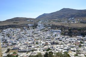 panoramic view of the white city at the foot of the mountains in greece