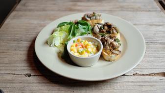 Gourmet Salad in a white plate on the table