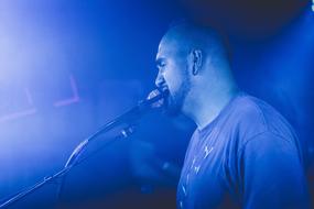 young bearded man singing