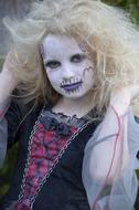 cool young Girl with halloween makeup and hairdress