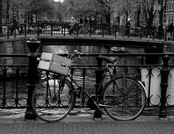 black and white, bike is parked on the bridge in Amsterdam