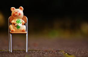 ceramic pig on a chair