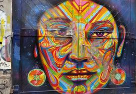 Colorful and beautiful graffiti with the woman face, on the wall in Berlin, Germany