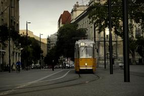 yellow tram on city street at dusk