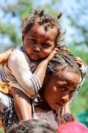 african woman with baby on her shoulders, Madagascar