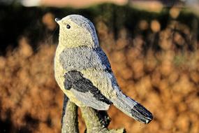 enchanting colorful Ceramic Bird Figure at blurred background