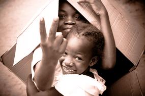 african Child Boys play with paper box
