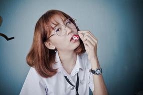 schoolgirl with cherry in hand