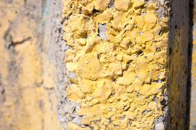 yellow paint on cement wall