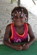 photo of a girl with African pigtails on the Caribbean sea beach