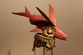 red wooden figurine of Flying fish