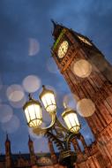 Big Ben tower and lights on the street in bokeh effect