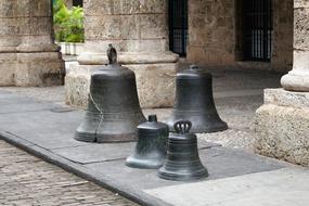 bells by the wall of a building in Cuba