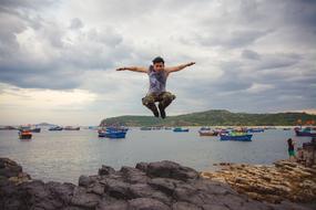 man jumping over the coast