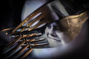 photo of a girl's face on a metal fork