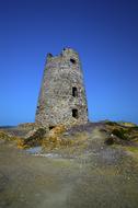 grey stone tower of medieval castle at sky, uk, wales, isle of anglesey