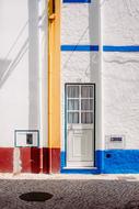 front door on a white facade on a sunny day