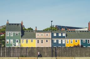 colorful houses behind a wooden fence