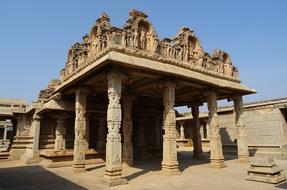 ornate stone carved pavilion in courtyard of Hazara Rama Temple, india, Hampi