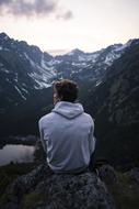 lonely man on the cliff above the lake