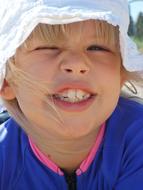 Face of funny caucasian child Girl with big teeth