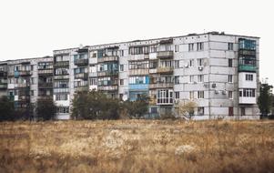 Building with colorful balconies near the plants