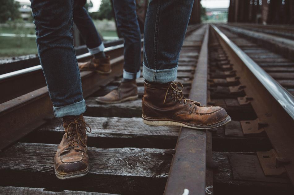 people standing on the railroad