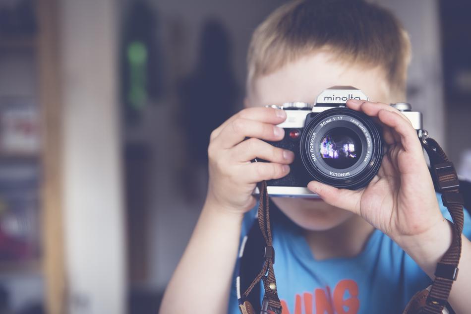boy with camera in blurred background