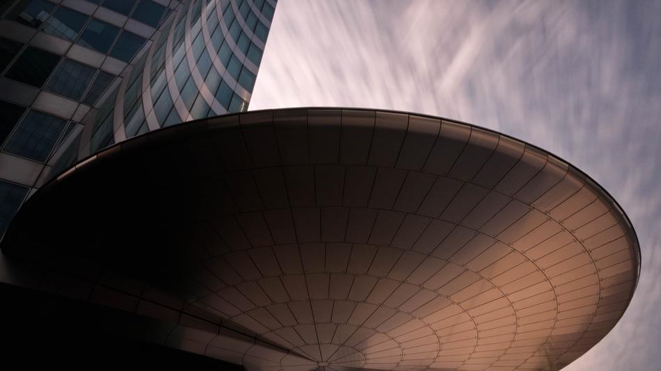 Low angle shot of the building with light and shadow, under the beautiful and colorful cloudy sky