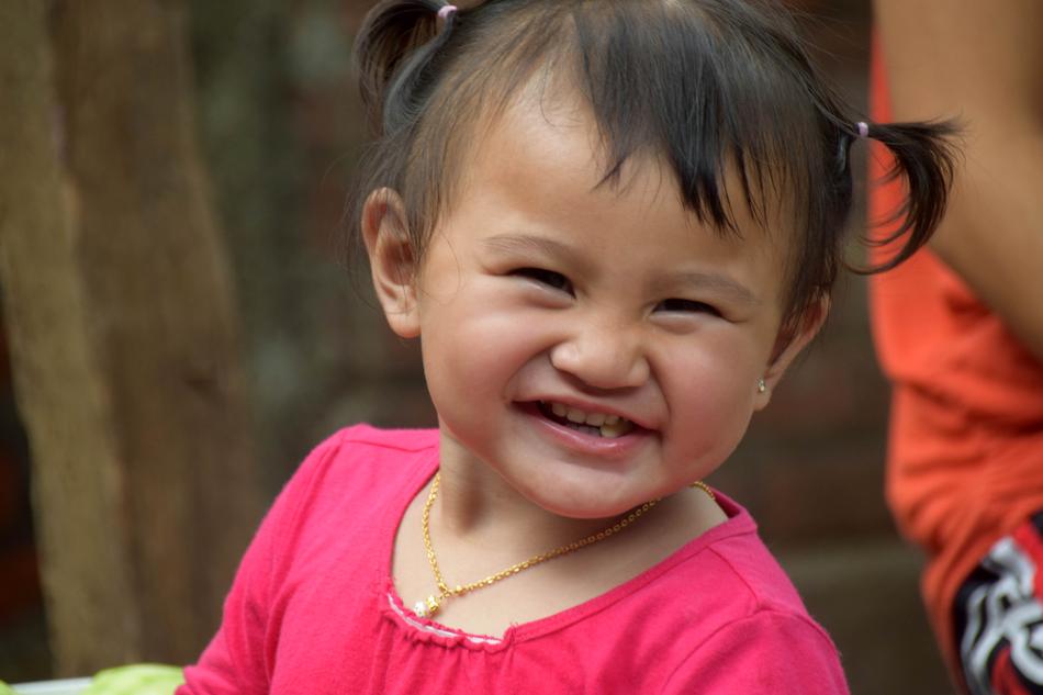 a child in a pink t-shirt happy