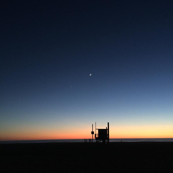 a one-legged building under a sky of stars