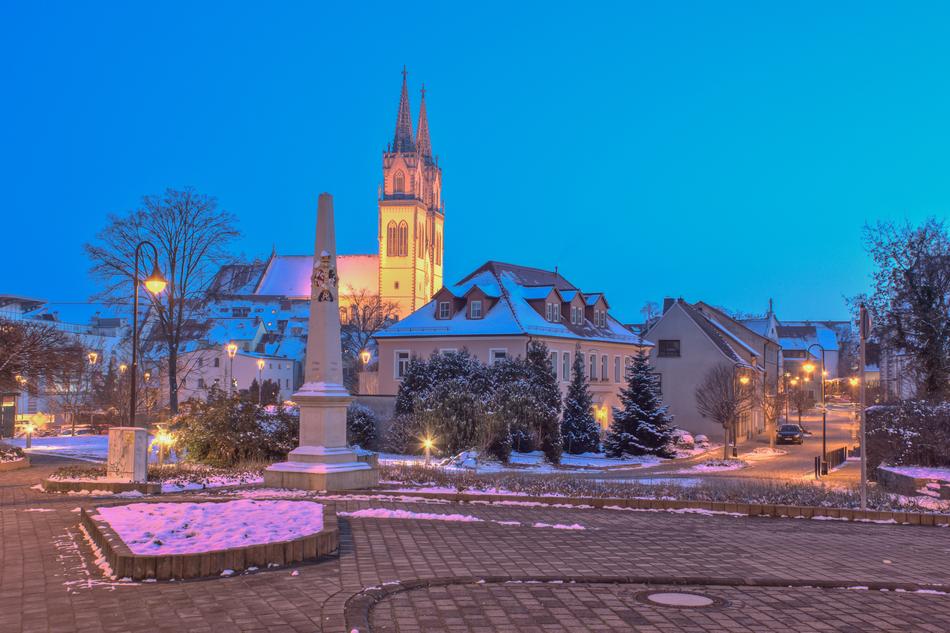 A large castle with a light on the sky background