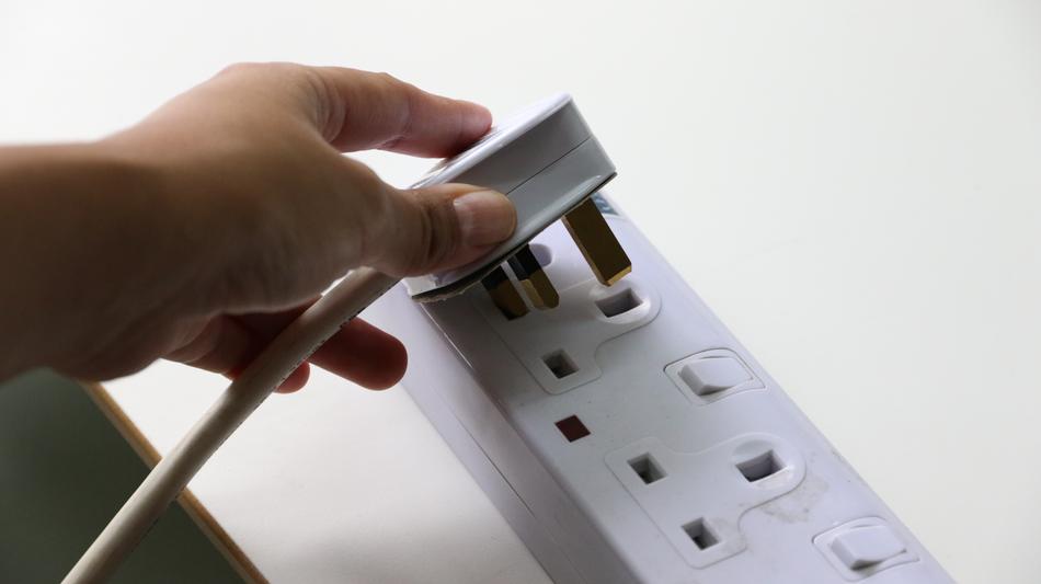 Person, connecting plug into the white socket, in light