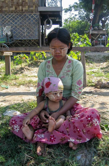 mother and child sitting on the ground in Burma