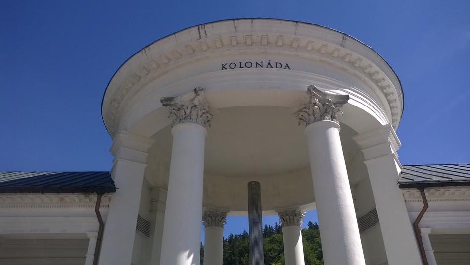 Beautiful building with columns in MariÃ¡nskÃ© LÃ¡znÄ, Czech Republic, at blue sky on background
