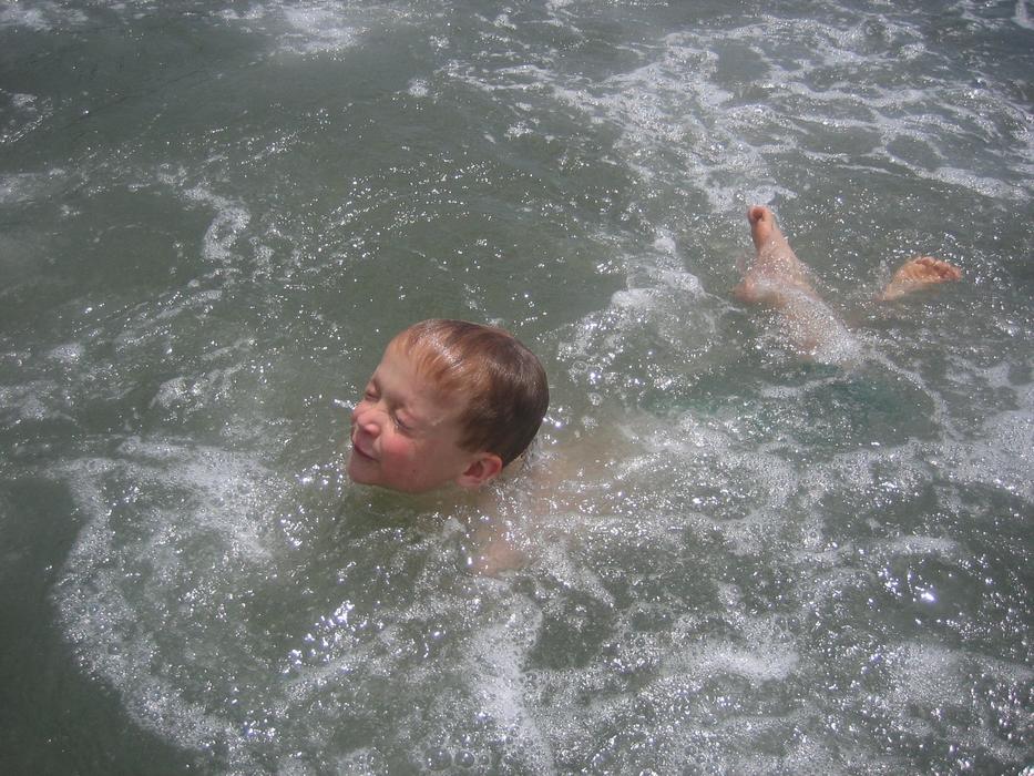 Kid swimming in water in summer